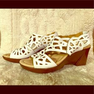 White leather cutout wedge sandals.